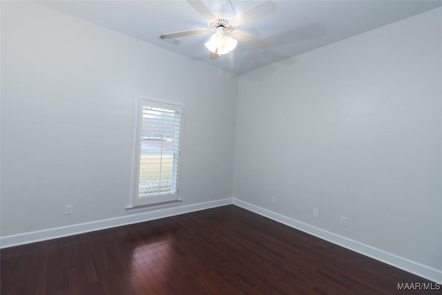 spare room with ceiling fan and dark hardwood / wood-style floors