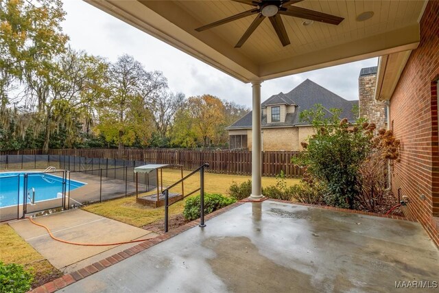 exterior space with a fenced in pool and ceiling fan