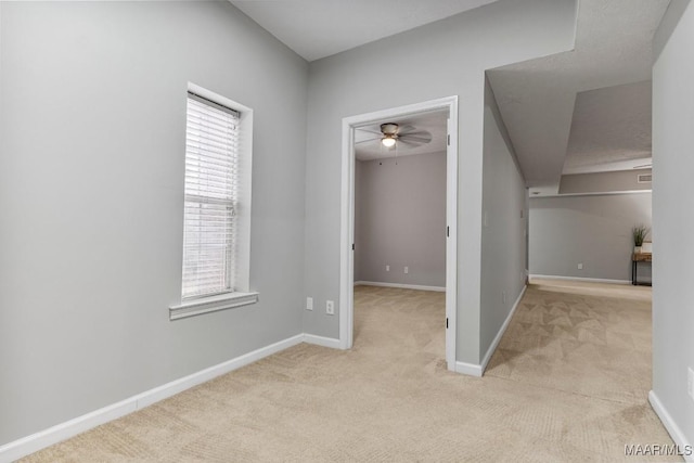 corridor featuring plenty of natural light and light colored carpet