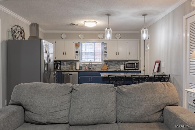 kitchen with stainless steel appliances, white cabinetry, and tasteful backsplash