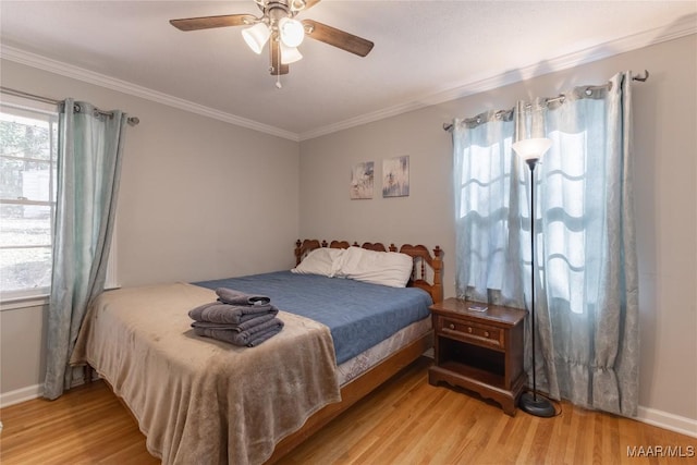 bedroom with light wood-type flooring, ceiling fan, and ornamental molding