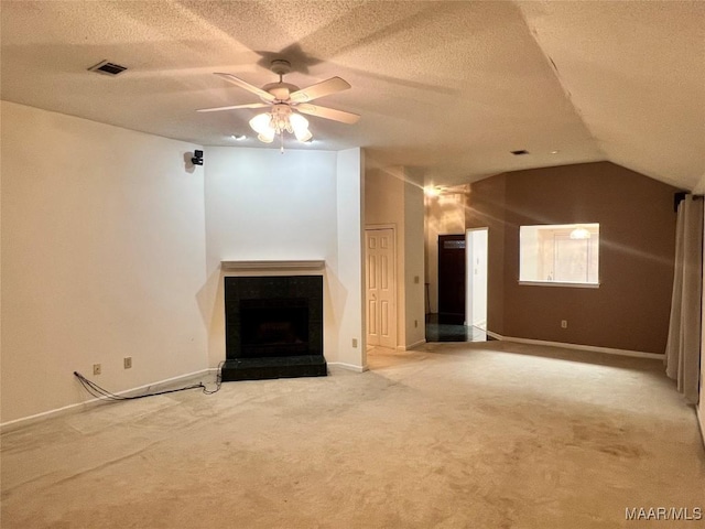 unfurnished living room with a textured ceiling, carpet floors, ceiling fan, and lofted ceiling