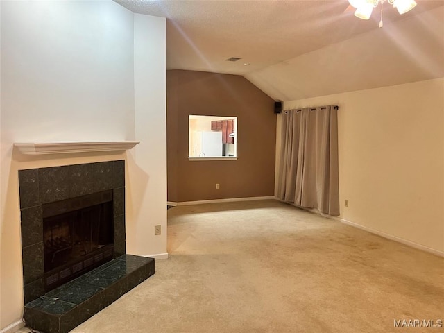 unfurnished living room with a fireplace, carpet floors, and lofted ceiling