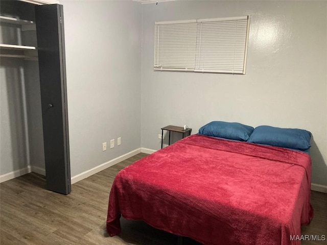 bedroom with dark hardwood / wood-style floors