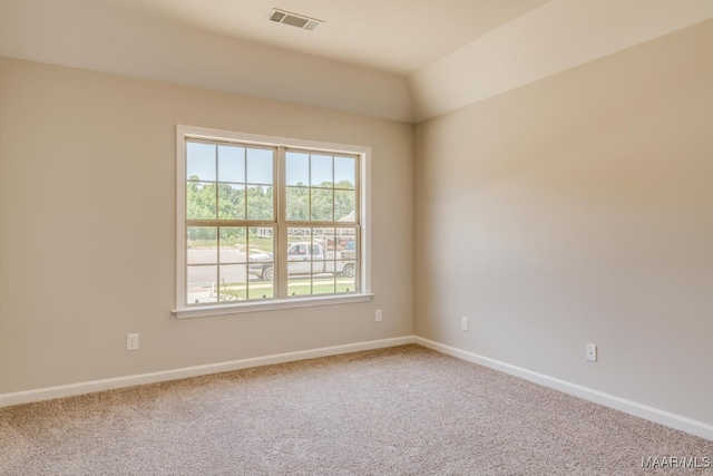 empty room featuring carpet, visible vents, and baseboards