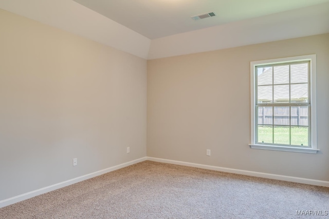 carpeted spare room with baseboards and visible vents