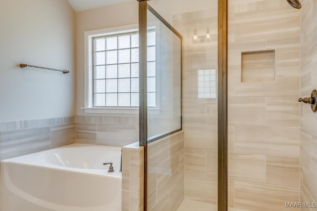 full bathroom featuring a stall shower and a bath