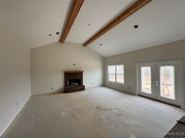 unfurnished living room with lofted ceiling with beams, a fireplace, visible vents, and french doors