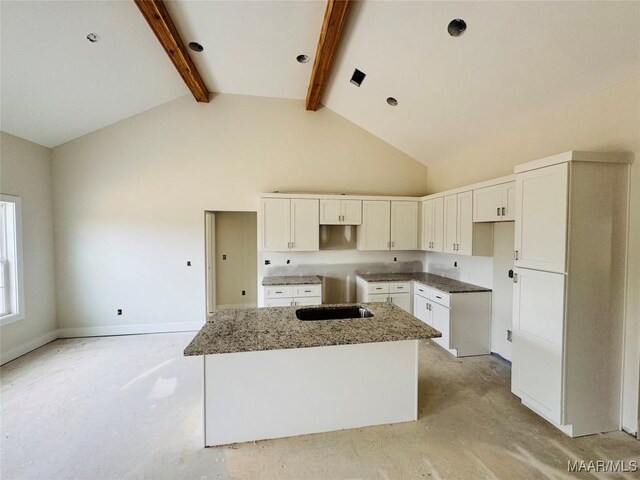 kitchen with high vaulted ceiling, stone countertops, white cabinetry, beamed ceiling, and a center island