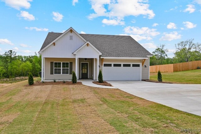 96 Madix Dr, Eclectic, AL 36024 - view of front of property featuring a porch, fence, driveway, a front lawn, and an attached garage