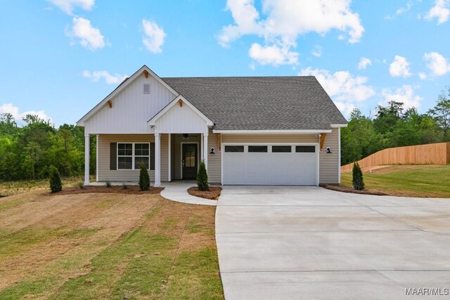 96 Madix Dr, Eclectic, AL 36024 - view of front of house with driveway, a front yard, an attached garage, fence, and a porch