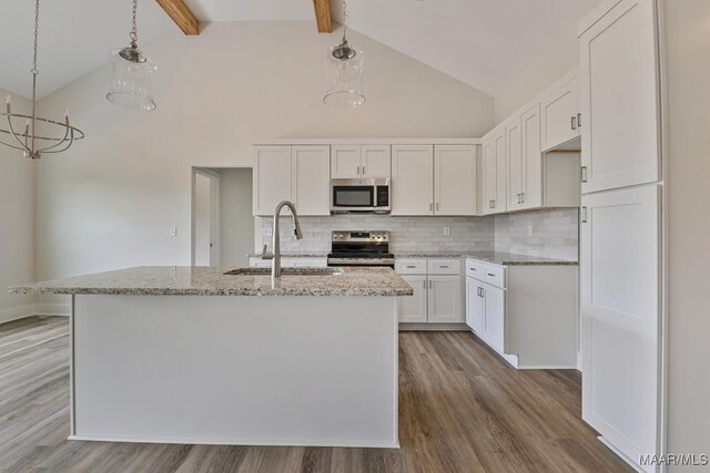 96 Madix Dr, Eclectic, AL 36024 - kitchen with appliances with stainless steel finishes, wood finished floors, backsplash, and a sink