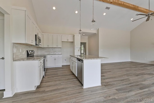 96 Madix Dr, Eclectic, AL 36024 - kitchen with lofted ceiling with beams, stainless steel appliances, light wood-type flooring, and backsplash