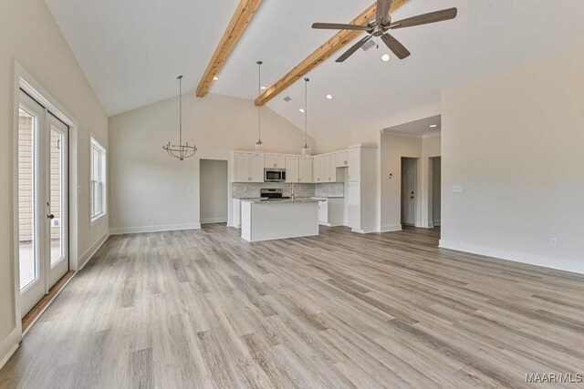 96 Madix Dr, Eclectic, AL 36024 - unfurnished living room featuring beamed ceiling, light wood finished floors, high vaulted ceiling, a ceiling fan, and baseboards