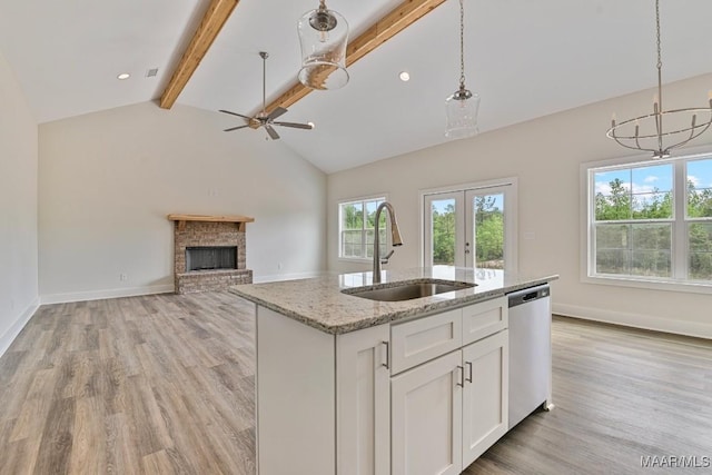 96 Madix Dr, Eclectic, AL 36024 - kitchen with stainless steel dishwasher, light wood-style flooring, beamed ceiling, a fireplace, and a sink