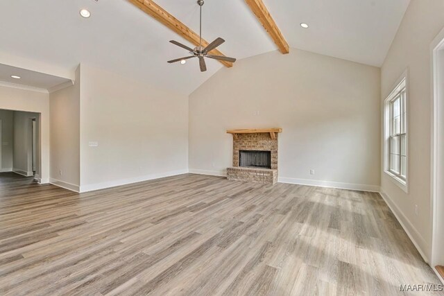 96 Madix Dr, Eclectic, AL 36024 - unfurnished living room with wood finished floors, ceiling fan, beamed ceiling, and a brick fireplace