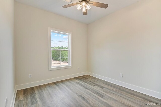 96 Madix Dr, Eclectic, AL 36024 - unfurnished room with baseboards, wood finished floors, and a ceiling fan