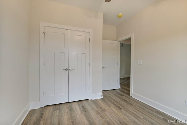 96 Madix Dr, Eclectic, AL 36024 - unfurnished bedroom with wood finished floors, a closet, and baseboards