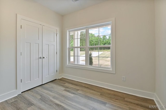 96 Madix Dr, Eclectic, AL 36024 - unfurnished bedroom featuring baseboards, wood finished floors, and a closet