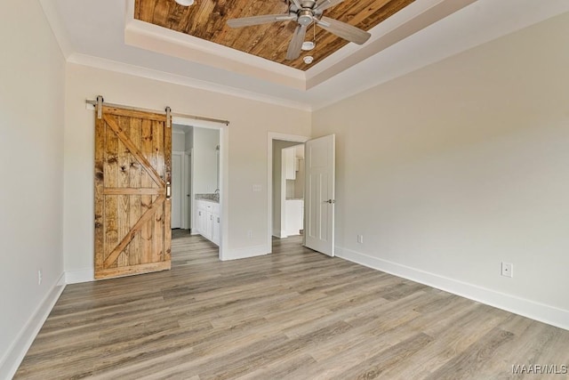 96 Madix Dr, Eclectic, AL 36024 - unfurnished bedroom featuring wood ceiling, wood finished floors, a barn door, and a tray ceiling