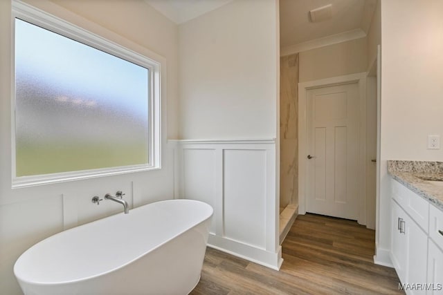 96 Madix Dr, Eclectic, AL 36024 - full bath with a soaking tub, a decorative wall, wood finished floors, vanity, and wainscoting