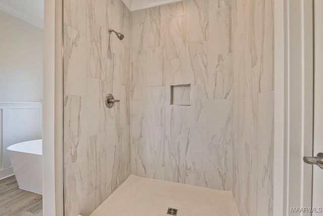 96 Madix Dr, Eclectic, AL 36024 - full bath featuring a freestanding tub, wood finished floors, a tile shower, and a wainscoted wall