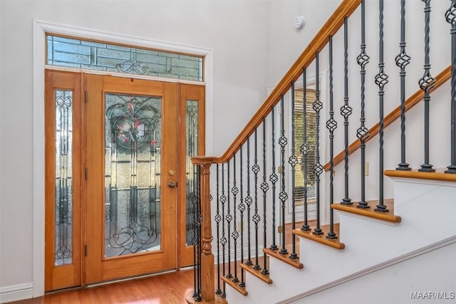 entrance foyer featuring hardwood / wood-style flooring and a healthy amount of sunlight