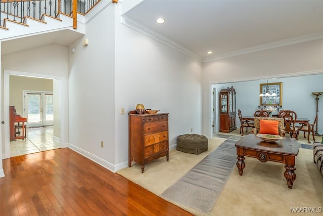 interior space featuring crown molding, hardwood / wood-style floors, and french doors