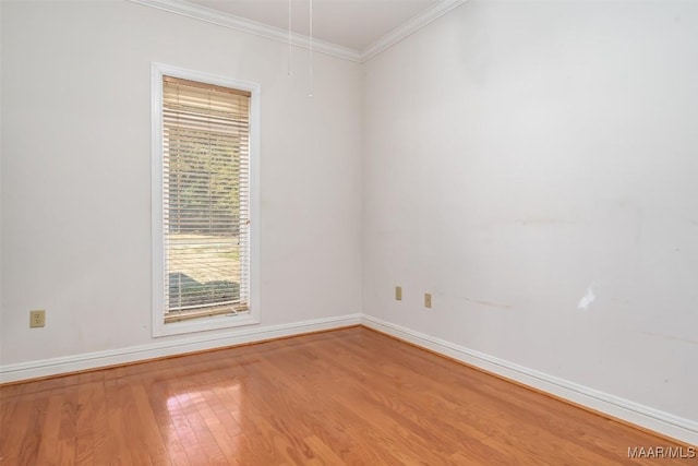 spare room with wood-type flooring and ornamental molding