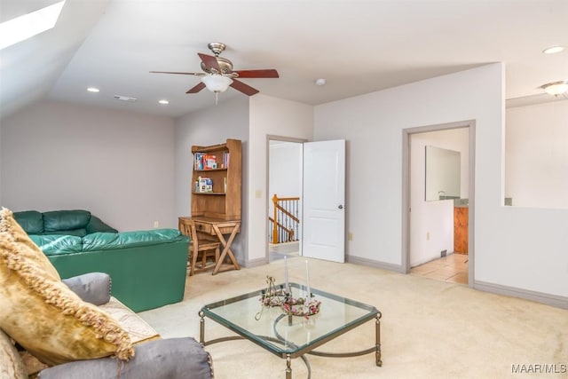 living room featuring light carpet, ceiling fan, and lofted ceiling with skylight