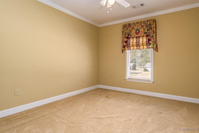 carpeted spare room featuring ceiling fan and crown molding