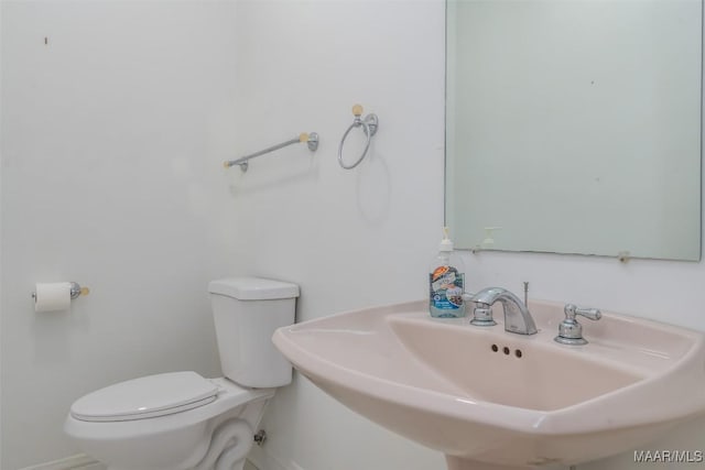 bathroom featuring toilet and sink