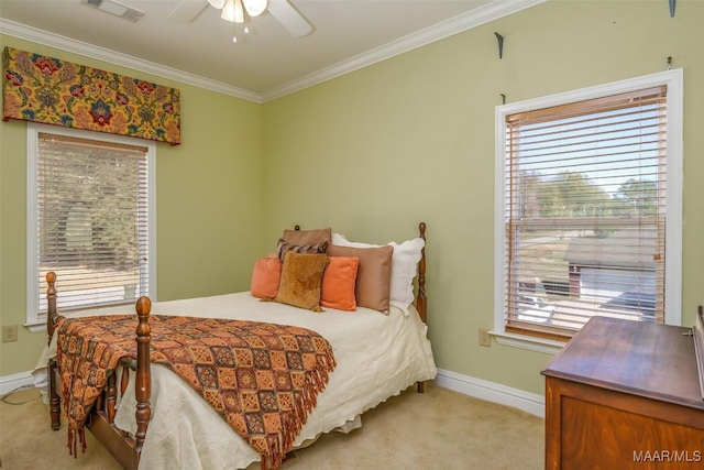 carpeted bedroom with ceiling fan, ornamental molding, and multiple windows