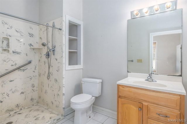 bathroom with tile patterned floors, vanity, toilet, and walk in shower