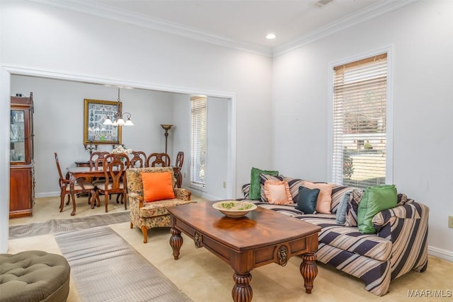 living room featuring crown molding, light carpet, and an inviting chandelier