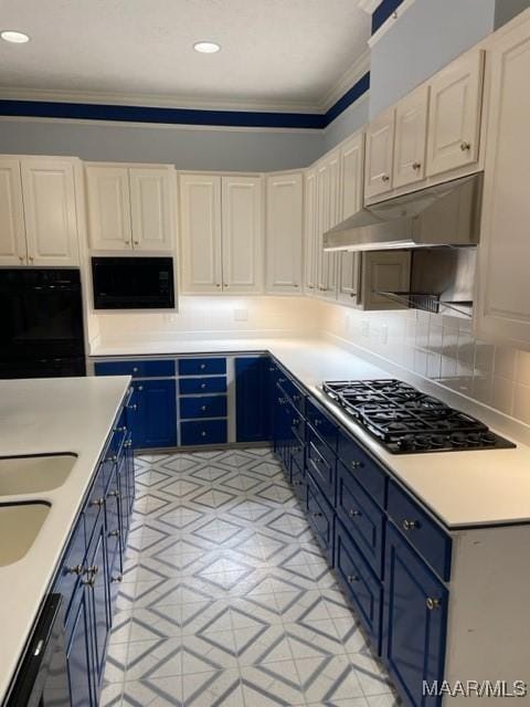 kitchen with blue cabinetry, sink, backsplash, black appliances, and ornamental molding