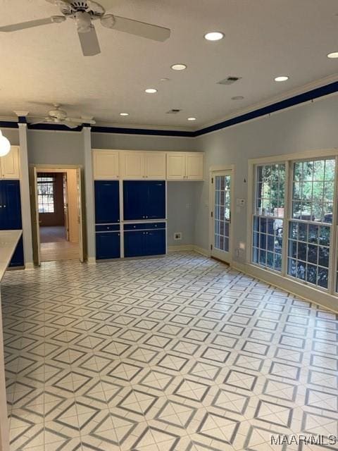 interior space with a healthy amount of sunlight, ceiling fan, and ornamental molding