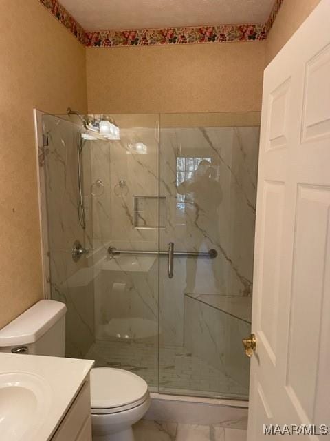 bathroom with vanity, toilet, and walk in shower