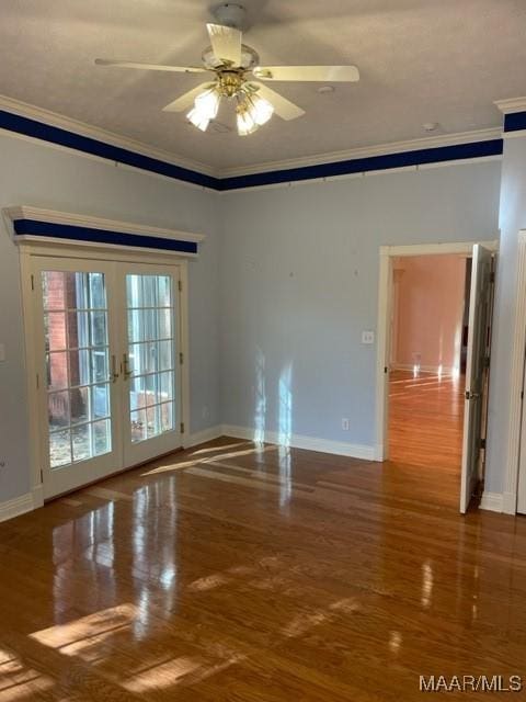 unfurnished room with ceiling fan, wood-type flooring, ornamental molding, and french doors