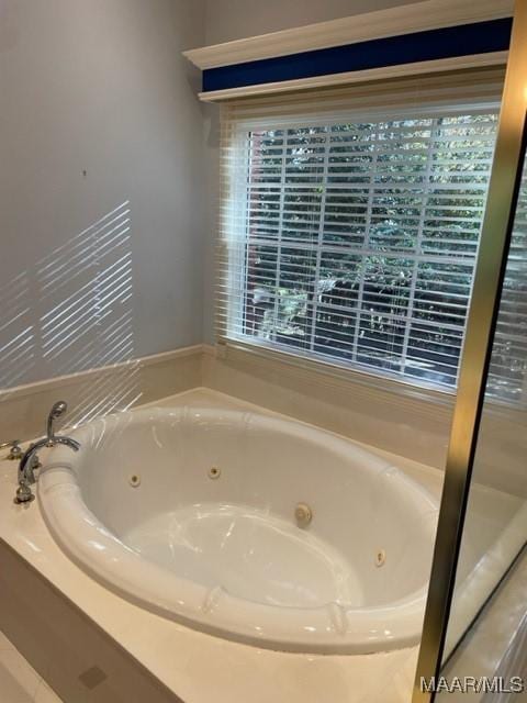 bathroom featuring tiled tub