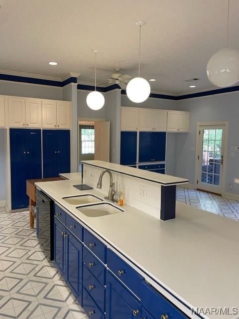 kitchen with sink, blue cabinetry, dishwasher, white cabinets, and hanging light fixtures