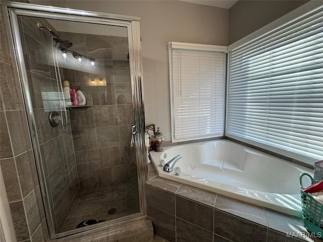 bathroom featuring independent shower and bath