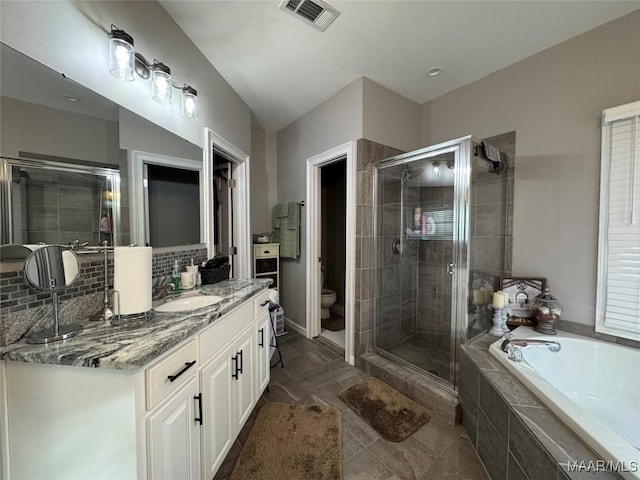 full bathroom with vanity, toilet, and independent shower and bath