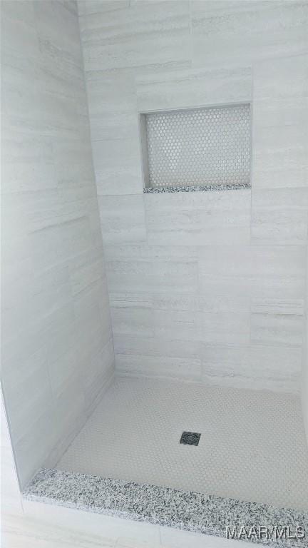 bathroom with a tile shower