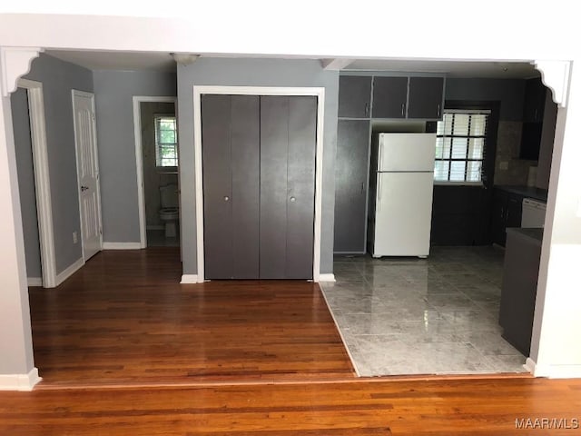 kitchen with dark hardwood / wood-style flooring, white appliances, and a wealth of natural light