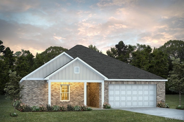 view of front of house with a garage and a lawn