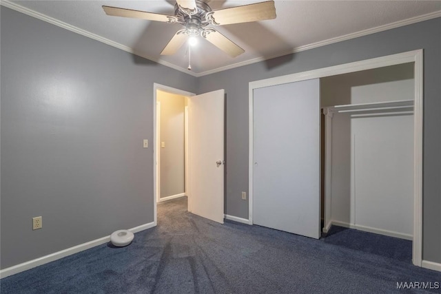 unfurnished bedroom featuring ceiling fan, dark carpet, ornamental molding, and a closet