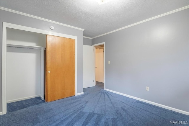 unfurnished bedroom with a closet, ornamental molding, a textured ceiling, and dark colored carpet