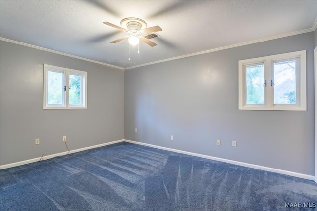 spare room featuring dark colored carpet, ceiling fan, and ornamental molding