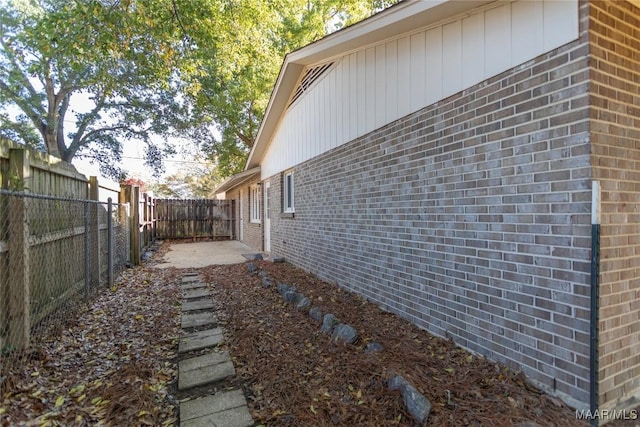 view of side of property with a patio area